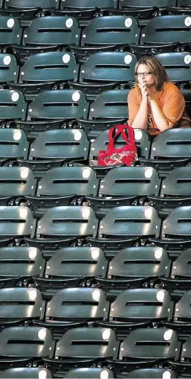  ?? Smiley N. Pool / Houston Chronicle ?? Greis Perez has plenty of room in section 124 at Minute Maid Park for most games as the Astros slide toward their third consecutiv­e 100-loss season.