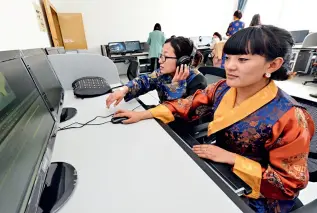  ??  ?? Staff members do post production editing of a program at the Lhasa Radio and Television Station on March 26, 2013.