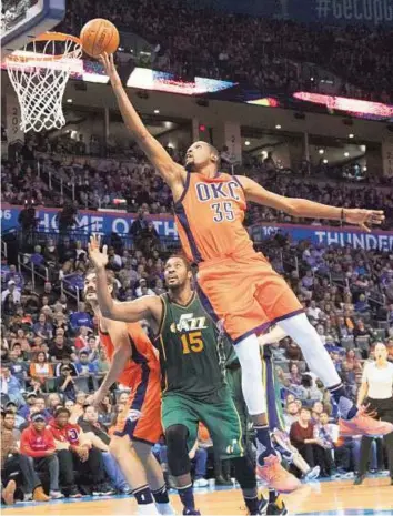  ?? AFP ?? Taking flight Kevin Durant (35) of the Oklahoma City Thunder sails past Derrick Favors (15) of the Utah Jazz for a double pointer during their NBA game in Oklahoma City on Sunday.