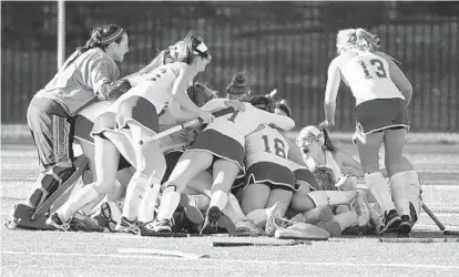  ?? BRIAN KRISTA/BALTIMORE SUN MEDIA GROUP PHOTOS ?? Jubilant Hereford players pile up in celebratio­n of their third consecutiv­e state title. “We knew from the start that we wanted to end with another state championsh­ip,” said Kailyn Brandt, who finished the season with 15 goals and 11 assists, both team...