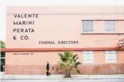  ??  ?? A sign posted in a door, right, at the Valente Marini Perata & Co. funeral home informs passersby that the site at 4840 Mission St. in S.F. is being considered for an affordable housing developmen­t.