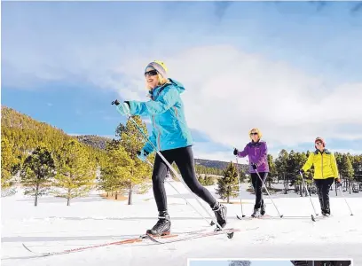  ?? COURTESY OF ANGEL FIRE RESORT NORDIC CENTER ?? Skiers glide along a trail at Angel Fire Nordic Center. Most cross-country skiing sites in the state are open.