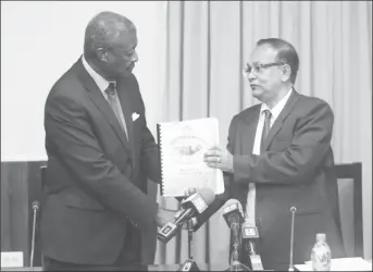  ??  ?? Auditor General Deodat Sharma (right) hands over the 2016 Audit Report to Speaker of the National Assembly Barton Scotland.