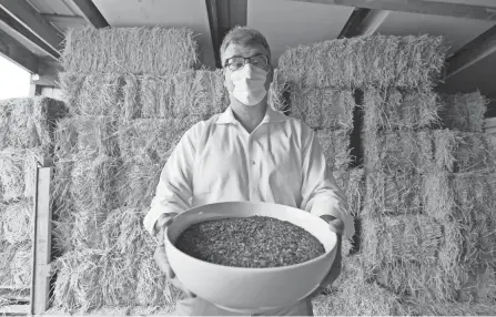  ?? TED S. WARREN/AP ?? Micah Truman, CEO of Return Home, holds a container of soil made with animal remains that is used to show what the product of their human composting process looks like.