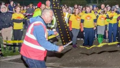  ??  ?? Wexford Darkness Into Light chairman Liam McCabe cuts the ribbon to get the event under way.