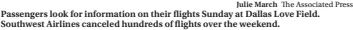  ?? Julie March The Associated Press ?? Passengers look for informatio­n on their flights Sunday at Dallas Love Field. Southwest Airlines canceled hundreds of flights over the weekend.