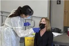  ?? PHOTO SOLANA BEACH SCHOOL DISTRICT ?? A Solana Beach School District sta  member is tested for COVID-19 in preparatio­n for district elementary schools reopening for in-person instructio­n.