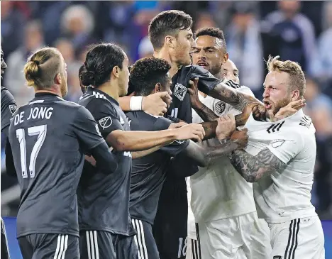  ?? PETER G. AIKEN/USA TODAY SPORTS/FILES ?? Sporting KC forward Johnny Russell, right, mixes it up with Vancouver forward Yordi Reyna on April 20 in Kansas City. Russell tormented the Caps in their last meeting, scoring a hat trick in the 6-0 victory and earning himself a special place in SKC’s Tifo lore.