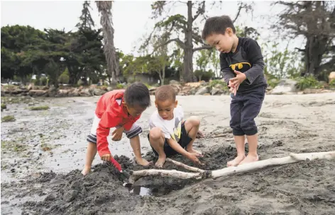  ?? PHOTOS BY LAURA MORTON ?? Six-year-old Jacob Wah, 6-year-old Sean Valentine and 4-year-old Davin Wah (left to right) play at Crown Memorial State Beach.