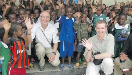  ??  ?? Barry Finlay and his son Chris with children at a preschool in Mwanza, Tanzania, in 2009. Finlay has continued to raise money for projects in Africa.