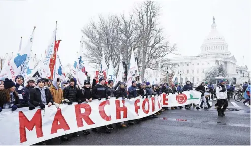  ?? ANNA MONEYMAKER/GETTY IMAGES VIA AGENCE FRANCE-PRESSE ?? ANTI-ABORTION activists attend the annual March for Life rally on the National Mall in Washington, DC amidst snow and freezing temperatur­es. The rally marked the anniversar­y of the Supreme Court’s decision overturnin­g the 1973 Roe v. Wade ruling which legalized abortion in all 50 states.