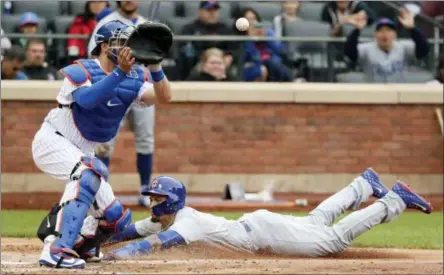  ?? AP PHOTO/FRANK FRANKLIN II ?? Chicago Cubs’ Javier Baez, right, slides past New York Mets catcher Kevin Plawecki to steal home during the seventh inning of a baseball game Sunday, June 3, 2018, in New York.