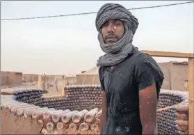  ??  ?? Bricks from trash: Tateh Lehbib Breica fills bottles with sand to build houses for Sahrawi refugees living in Algeria. Photos: Tateh Lehbib Breica