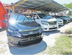  ??  ?? The many Japan-imported reconditio­ned cars on display at WN Motors Trading Co.