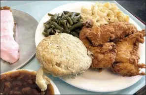 ?? Arkansas Democrat-Gazette/ERIC E. HARRISON ?? A “Meat &amp; Three” lunch at Cathead’s Diner consisted of fried chicken tenders, green beans, mac and cheese and baked beans with a cathead biscuit.