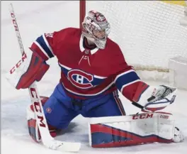  ?? GRAHAM HUGHES, THE CANADIAN PRESS ?? Canadiens star goaltender Carey Price makes a glove save against the Vancouver Canucks in the first period in Montreal on Sunday night. The Habs beat the Canucks, 5-2.