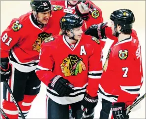  ?? The Associated Press ?? Chicago Blackhawks’ Duncan Keith is congratula­ted by Marian Hossa, left, and Brent Seabrook
after scoring Jan. 22. The Blackhawks faced the rival Vancouver Canucks Friday night.