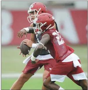  ?? NWA Democrat-Gazette/ANDY SHUPE ?? Arkansas running back Trelon Smith (front) runs through a drill with quarterbac­k Nick Starkel during a practice last week. Smith, a sophomore transfer from Arizona State, must redshirt this season. “This kid’s got a chance to be really special,” Coach Chad Morris said after Saturday’s scrimmage.