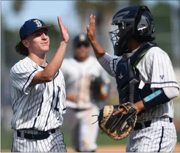  ?? PHOTO BY ANDY HOLZMAN ?? Birmingham pitcher Daniel Flores is congratula­ted after beating El Camino Real during their West Valley League game.