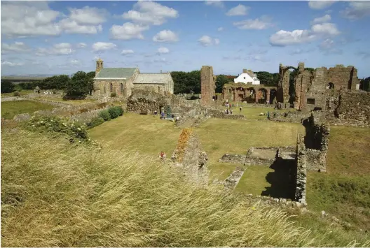  ??  ?? ABOVE The ruins of Lindisfarn­e Priory, with St Mary’s church on the left. Lindisfarn­e’s monastery was founded around 634 by Saint Aidan and became a hub of Christiani­ty while enduring Viking raids in the 8th and 9th centuries