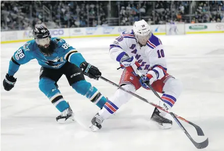  ?? — THE ASSOCIATED PRESS FILES ?? San Jose Sharks’ Brent Burns, left, defends against New York Rangers’ J.T. Miller on Tuesday. The Sharks’ 5-4 win snapped a six-game losing skid. Playoff-bound teams like the Sharks, Rangers and Minnesota Wild, are trying shake late-season funks.