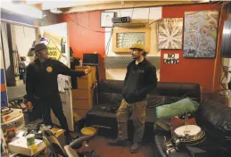  ??  ?? Shane Sischo, (left) and Isaac Blackwood, who used to live at Deathrap, are working in a different warehouse that they are renovating with wood and items from Deathtrap, building their own new space to live and work at a location they don’t want to...