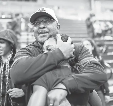  ??  ?? Kentucky track and field coach Lonnie Greene hugs runner Celera Barnes at the NCAA Track and Field Indoor Championsh­ips. ISAAC JANSSEN/ UK ATHLETICS