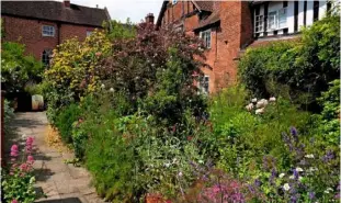  ??  ?? Erasmus Darwin’s timber and brick house and garden, full of early summer colour.