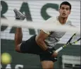  ?? THIBAULT CAMUS — THE ASSOCIATED PRESS ?? Spain's Carlos Alcaraz serves during his 6-4, 6-4, 6-2victory over Sebastian Korda in the third round of the French Open on Friday.