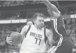  ?? TONY GUTIERREZ/AP ?? Andrew Wiggins guards Luka Donic during Game 4 of the Western Conference finals Tuesday. Doncic led the Mavs to the victory, but the Warriors lead the series 3-1.