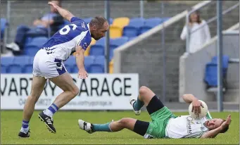  ??  ?? Paudge McWalter sends Baltinglas­s’ Billy Cullen flying during the SFC clash in Joule Park, Aughrim.