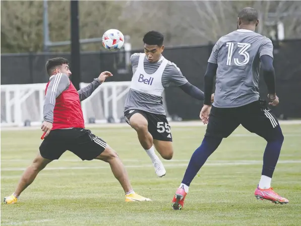  ?? BOB FRID/VANCOUVER WHITECAPS FC ?? Whitecaps midfielder Michael Baldisimo jumps past forward Lucas Cavallini during team training at UBC this week.