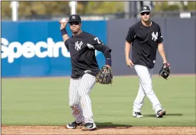  ?? AP/LYNNE SLADKY ?? Seattle Seahawks quarterbac­k Russell Wilson throws a ball while participat­ing in fielding drills with the New York Yankees on Monday. Wilson, who was acquired in a trade with the Texas Rangers, has no plans on giving up his NFL career to play baseball,...