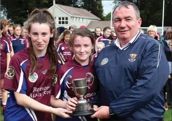  ??  ?? The Kelly twins, Yvonne and Lisa, joint captains of Bunclody, accepting the trophy from Donnacha Kerins (Co. Chairman) in Farmleigh on Sunday.