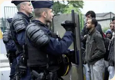  ??  ?? La police française face à des migrants