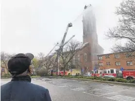  ?? BARBARA HADDOCK TAYLOR/BALTIMORE SUN ?? Firefighte­rs battle a four-alarm blaze at the Urban Bible Fellowship Church on Saturday in Baltimore. The department said no injuries were reported from the fire.