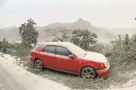  ?? UWI Seismic Research Center / AFP / Getty Images ?? Heavy ashfall coats the terrain Saturday near La Soufriere volcano, which erupted the day before on the eastern Caribbean island of St. Vincent.