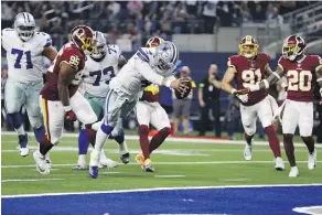  ?? RON JENKINS/THE ASSOCIATED PRESS ?? Dallas Cowboys quarterbac­k Dak Prescott dives for a touchdown against the Redskins on Thursday.