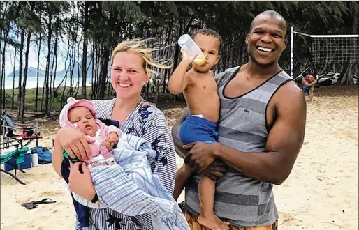  ?? COURTESY OF MYENI FAMILY/BICKERTON LAW GROUP VIA AP ?? Lindani Myeni stands on a beach in Waimanalo, Hawaii, with wife Lindsay and their two children in 2021. Lindani Myeni was fatally shot by Honolulu police after he physically attacked officers, who responded when an upset occupant of a home complained a stranger had entered uninvited wearing a feathered headband and making bizarre comments. Results of studies of Myeni’s brain tissue show the 29-year-old South African rugby player had Stage 3 CTE.