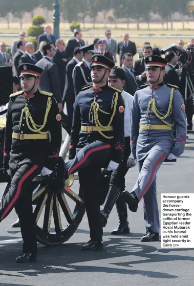  ?? EPA ?? Honour guards accompany the horsedrawn carriage transporti­ng the coffin of former Egyptian leader Hosni Mubarak as his funeral was held amid tight security in Cairo