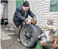 ?? ?? Volodymr Skorik, 68, at his home with a wheel from a Russian tank destroyed during the Battle of Brovary, top