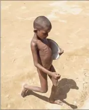  ?? FRED DUFOUR/AFP ?? A Rohingya Muslim boy carries his plate to receive food at Balukhali refugee camp in Cox’s Bazar on October 1.