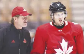  ?? CP PHOTO ?? Team Canada head coach Mike Babcock talks with captain Sidney Crosby during practice ahead of the World Cup of Hockey finals in Toronto.