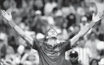  ?? Clive Brunskill Getty Images ?? JUAN MARTIN DEL POTRO of Argentina enjoys the moment after battling through a fever and feeling ill to rally from two sets down to defeat Dominic Thiem of Austria in the fourth round of the U.S. Open.