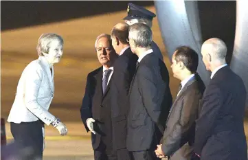  ?? — AFP photo ?? May is welcomed by Argentinia­n Senate’s temporary President Federico Pinedo (second left) upon arrival at Ezeiza Internatio­nal airport in Buenos Aires on teh eve of the G20 Leaders’ Summit.