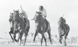  ?? LESLIE MARTIN/GULFSTREAM PARK/COURTESY ?? Heart to Heart, third from left, with Julien Leparoux aboard, wins the $300,000 Grade I Gulfstream Park Turf on Saturday.