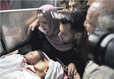  ?? MOHAMMED SALEM / REUTERS ?? Familiares de dos menores palestinos muertos por el ataque israelí.