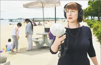  ?? Erik Trautmann / Hearst Connecticu­t Media ?? Board of Education member Sarah Lemieux at Calf Pasture Beach in Norwalk on Wednesday. Lemieux has spent the past several months created a mixed-media audiovisua­l installati­on that will be exhibited at the Rene Soto Gallery beginning in July. She traveled around the city collecting recordings of people saying “We Are Norwalk,” which she then edited together and overlayed with visuals of the correspond­ing neighborho­ods and landmarks in Norwalk where the sounds were collected.