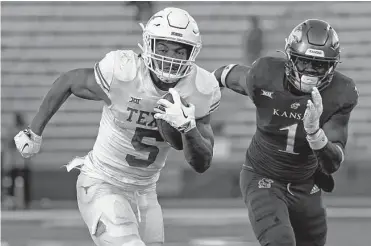  ?? Ed Zurga/getty Images ?? Texas running back Bijan Robinson rushed for a career-high 243 yards and scored four touchdowns on Saturday against Kansas in Lawrence, Kan. The Longhorns trounced the Jayhawks 55-14.