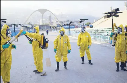  ?? AP ?? Health workers get ready to spray insecticid­e to combat Aedes aegypti mosquitoes that transmit the Zika virus under the bleachers of the Sambadrome in Rio de Janeiro Tuesday.